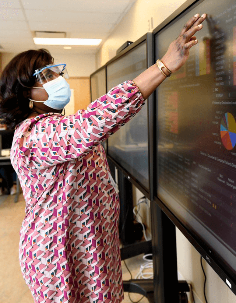 A staff member looks up information on a large display screen in the Operational Command Centre. 